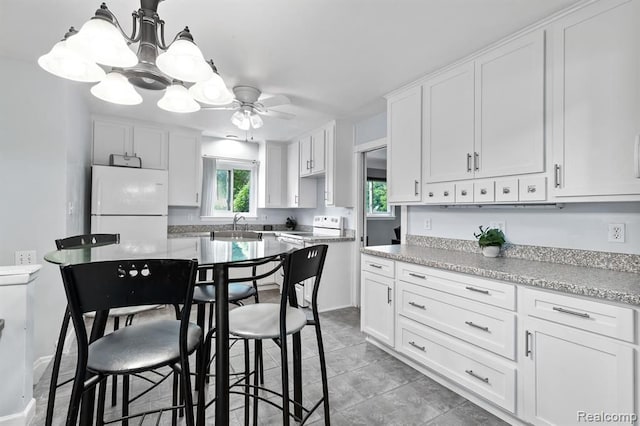 kitchen with white cabinetry, white appliances, ceiling fan, and sink