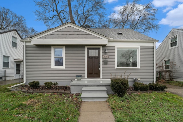 bungalow-style house with a front yard