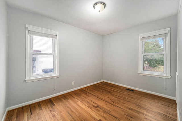 spare room with wood-type flooring