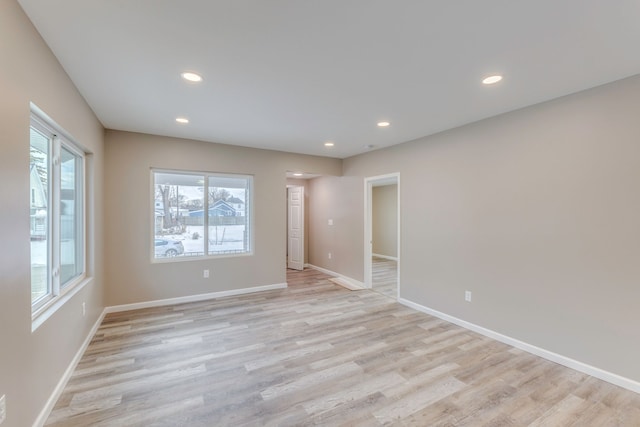 unfurnished room with light wood-type flooring