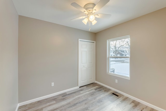 spare room featuring ceiling fan and light wood-type flooring