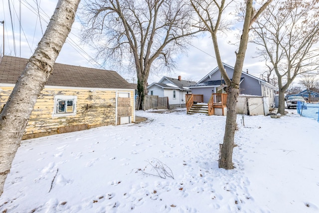 yard covered in snow featuring a wooden deck