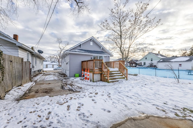 snow covered property featuring a deck