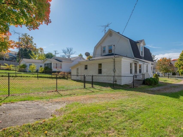 view of side of home with a yard