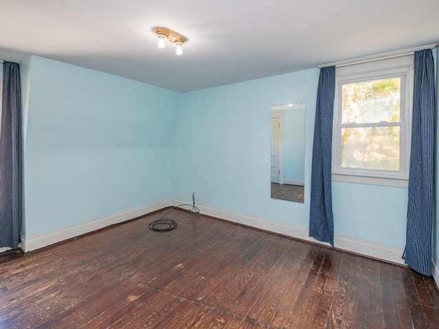 unfurnished room featuring dark wood-type flooring