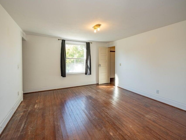 spare room with dark hardwood / wood-style floors