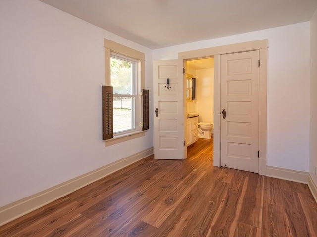 empty room with dark hardwood / wood-style flooring