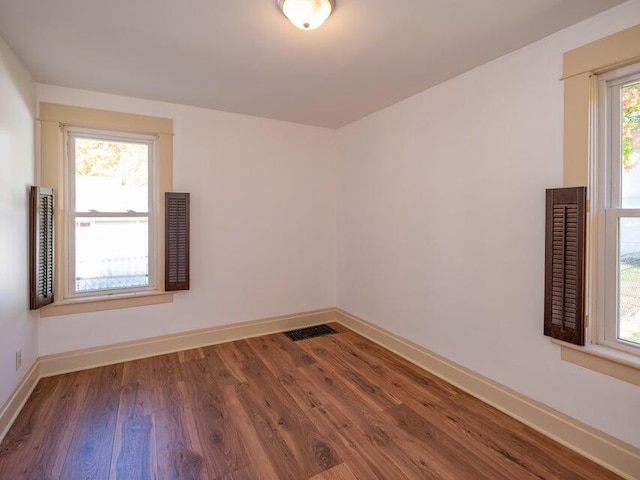 unfurnished room with dark hardwood / wood-style floors