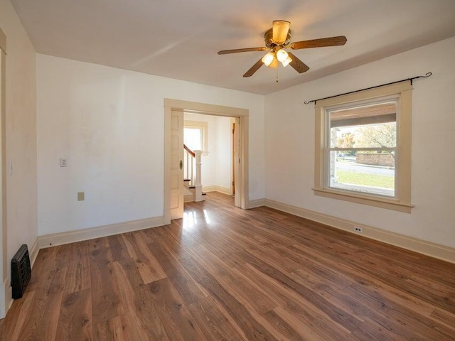 spare room with dark hardwood / wood-style floors and ceiling fan