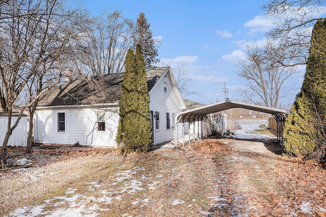 view of home's exterior with a carport