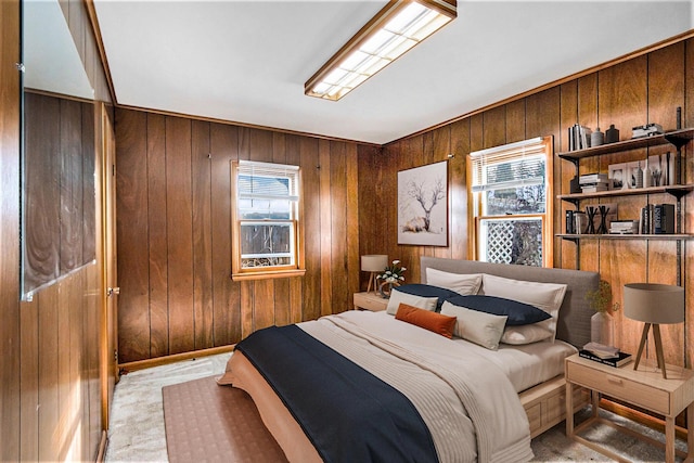 bedroom featuring multiple windows and wood walls