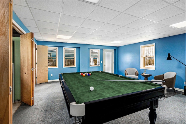 recreation room with dark colored carpet and a paneled ceiling