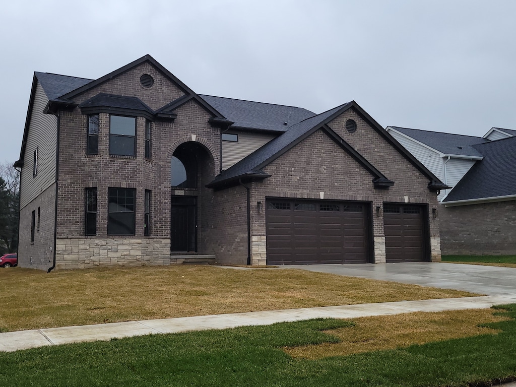 french country inspired facade with a garage and a front yard