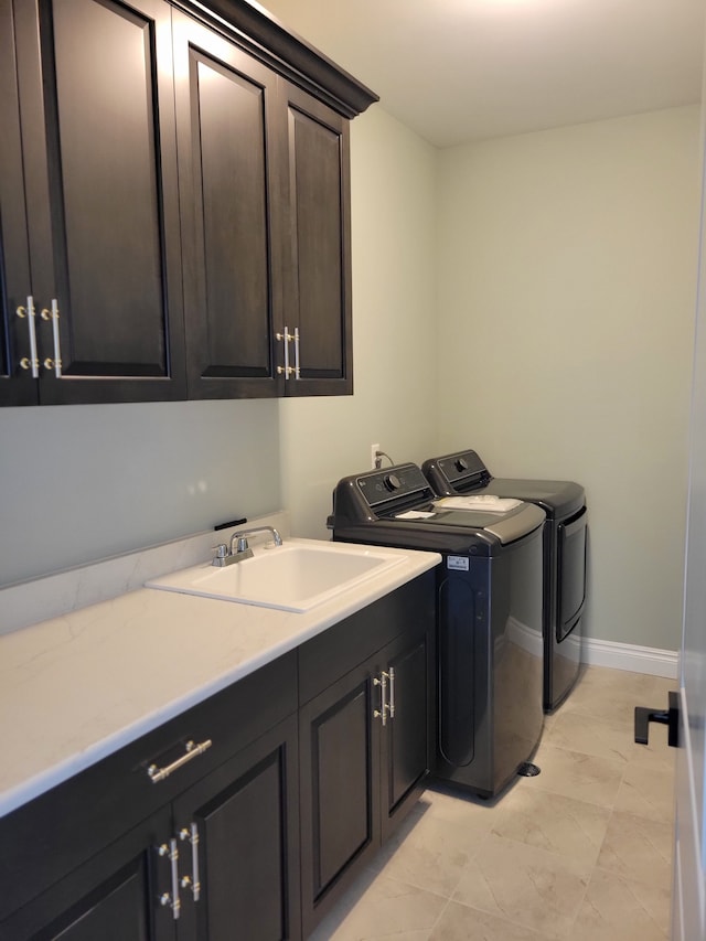 laundry area with cabinets, sink, and independent washer and dryer