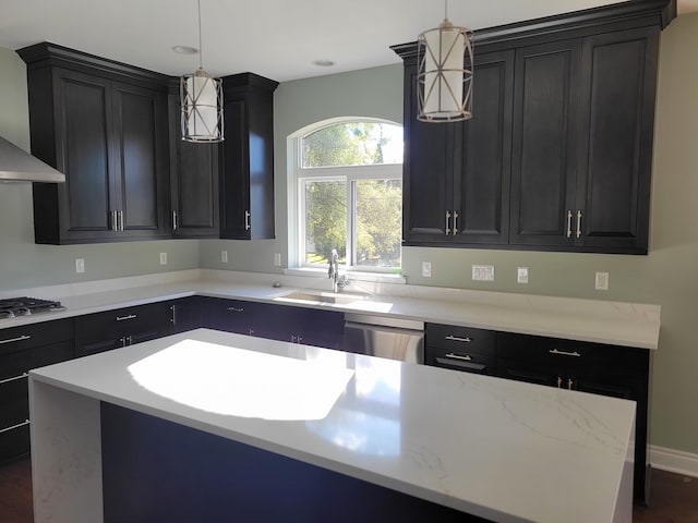 kitchen featuring a kitchen island, appliances with stainless steel finishes, sink, and decorative light fixtures