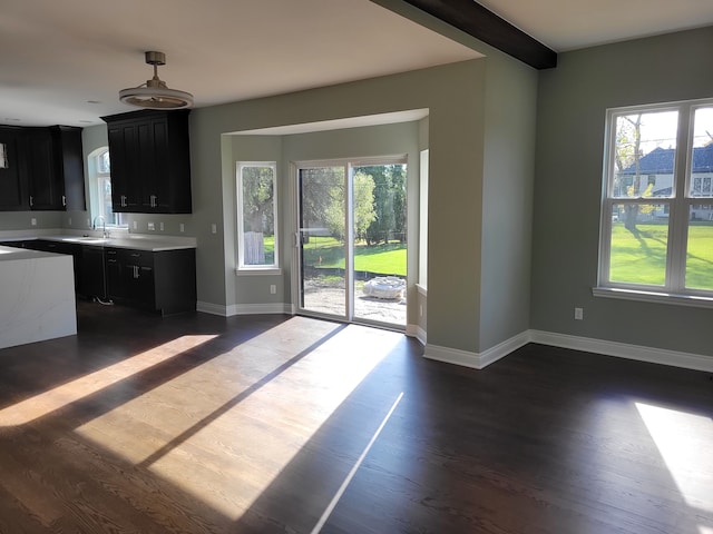 kitchen with dark hardwood / wood-style flooring, sink, and beam ceiling