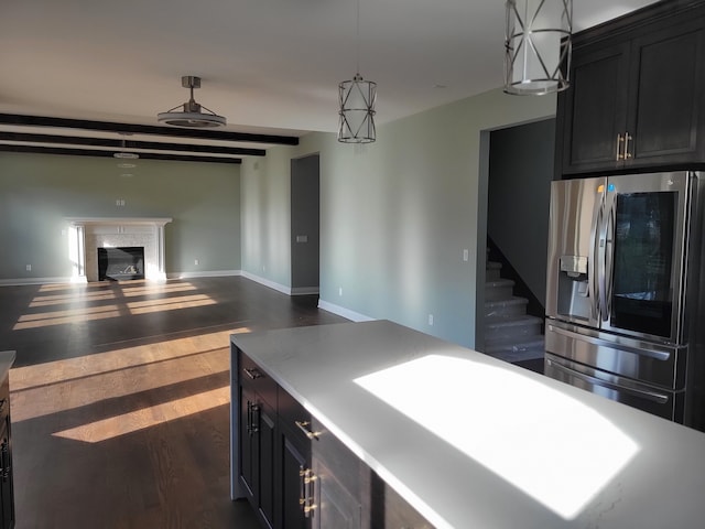 kitchen featuring pendant lighting, stainless steel fridge, dark hardwood / wood-style floors, and a center island