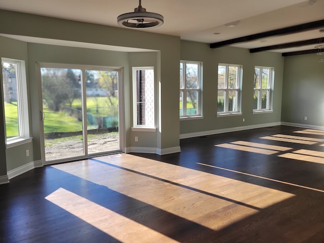 doorway with dark hardwood / wood-style floors and beam ceiling