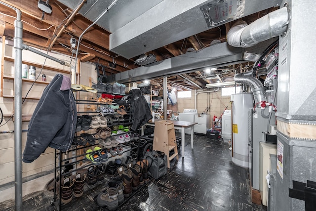 basement featuring washing machine and dryer and water heater