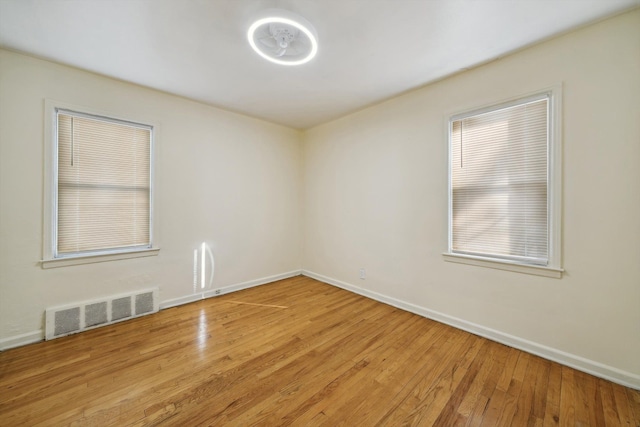 empty room with light hardwood / wood-style floors