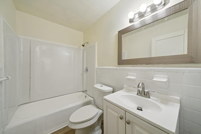 full bathroom with vanity, shower / washtub combination, tile walls, and toilet