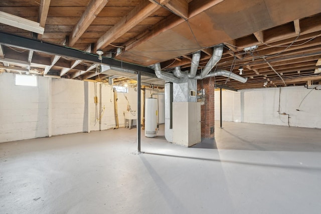 basement featuring sink and water heater