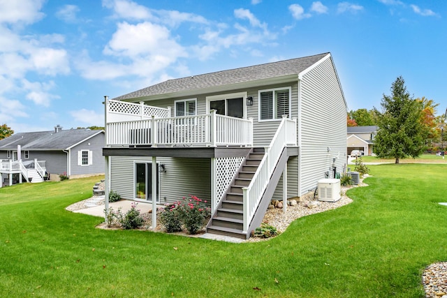 rear view of property featuring a yard, a patio area, central air condition unit, and a deck