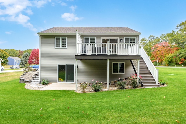 back of property with a patio, a wooden deck, and a lawn