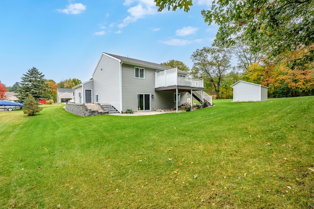 back of house featuring a deck and a lawn