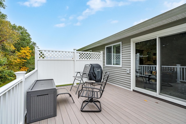 wooden terrace featuring a grill