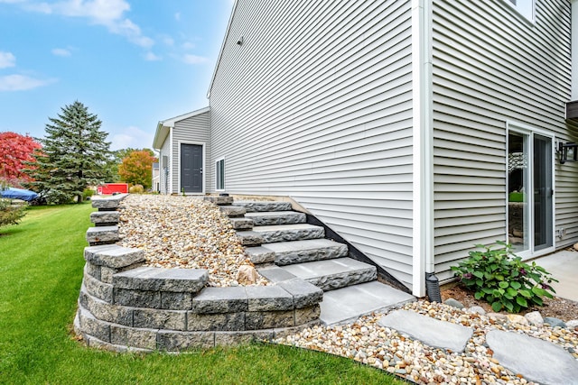 view of home's exterior with a yard