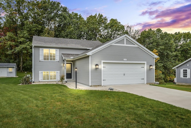 view of front of home featuring a garage and a lawn