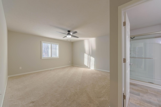 empty room with light carpet and ceiling fan