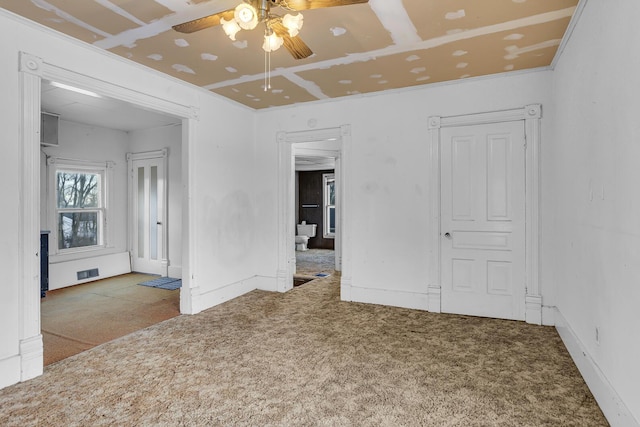 carpeted spare room with ceiling fan