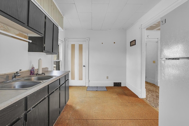 kitchen with sink and white refrigerator