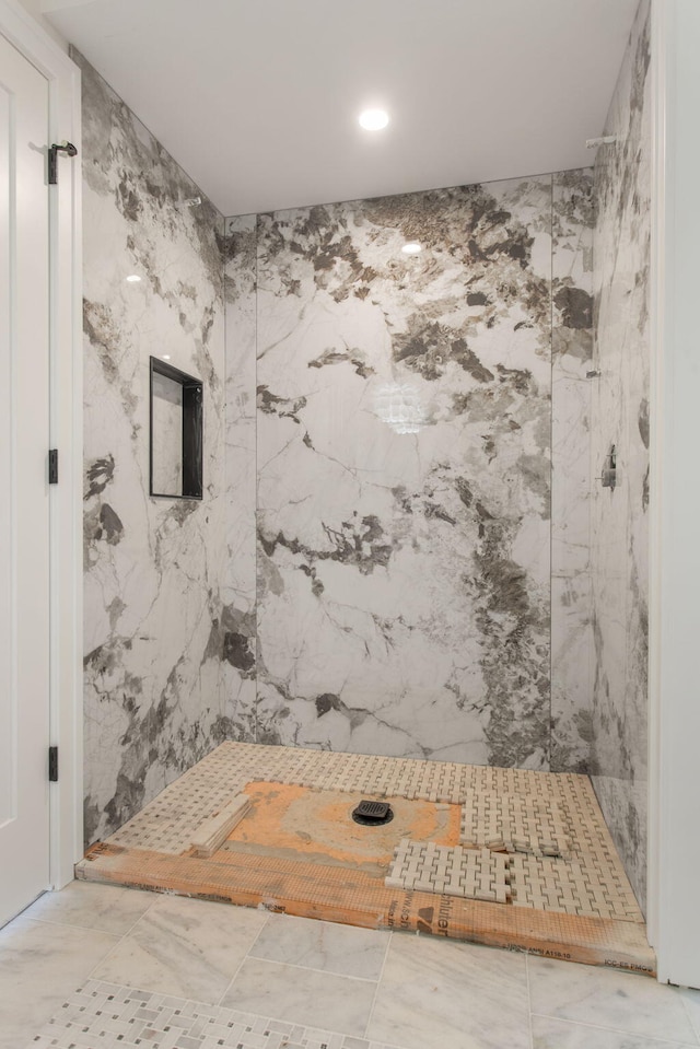 bathroom with tiled shower