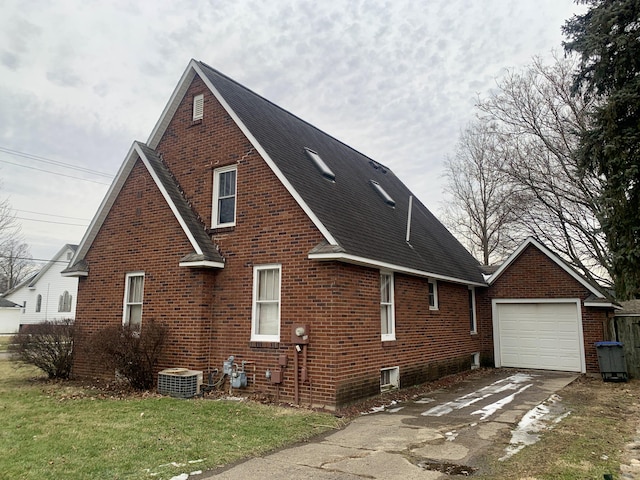 view of side of property with a garage, a lawn, and central air condition unit