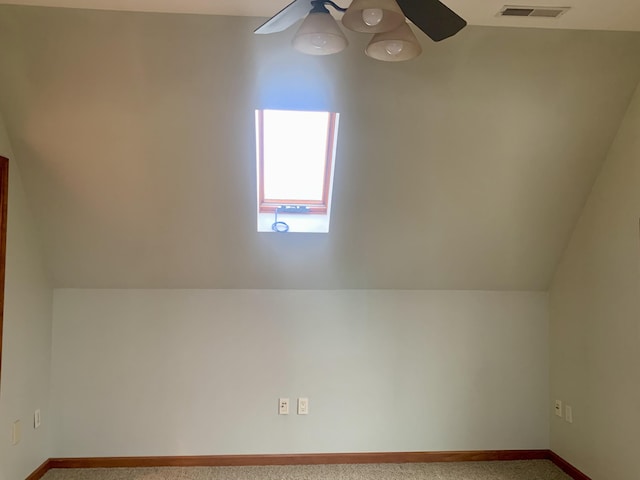 additional living space featuring carpet, lofted ceiling, and ceiling fan