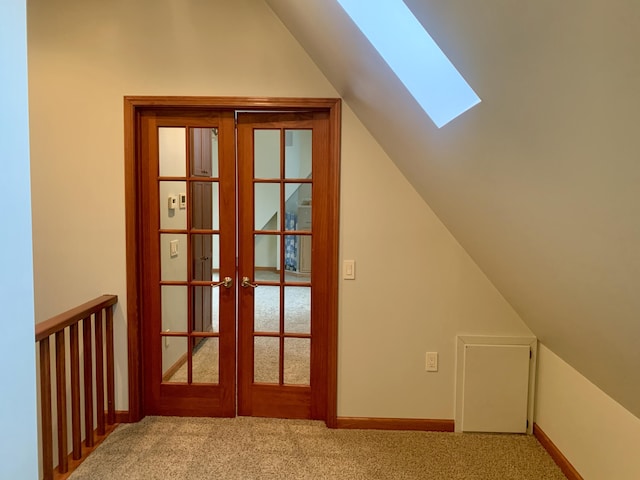 bonus room with lofted ceiling with skylight, carpet floors, and french doors