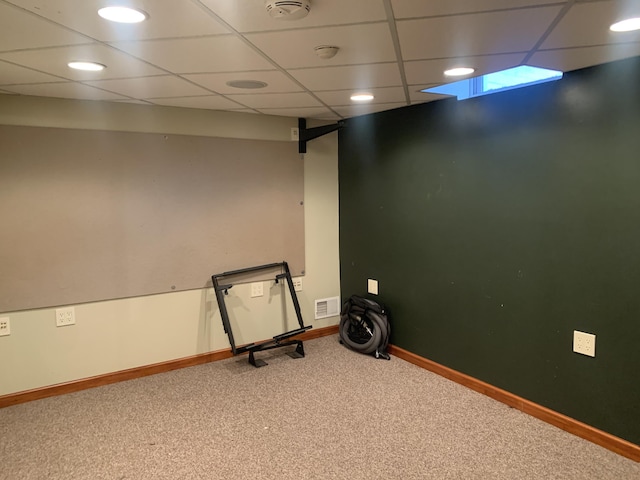 interior space featuring a paneled ceiling and carpet