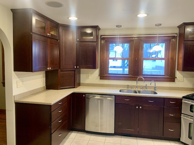 kitchen featuring sink, decorative light fixtures, stainless steel appliances, and light tile patterned floors