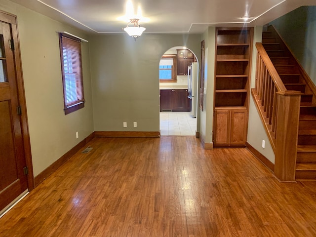 unfurnished dining area with light hardwood / wood-style floors and a healthy amount of sunlight