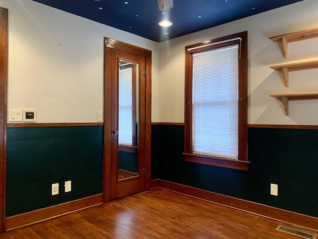 spare room with wood-type flooring