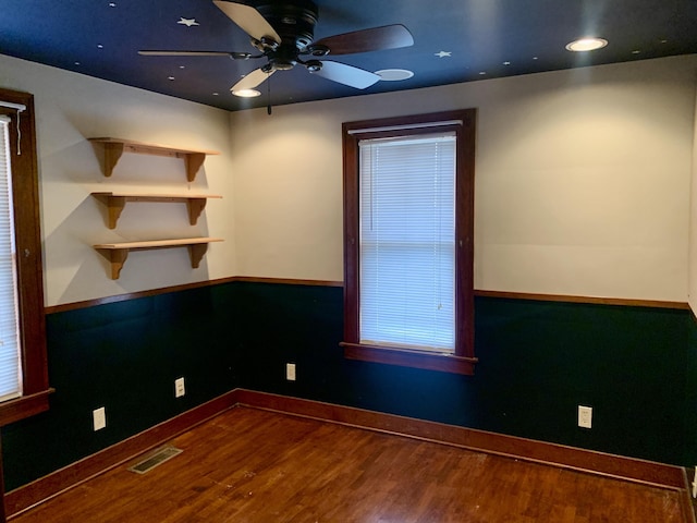 empty room with wood-type flooring and ceiling fan