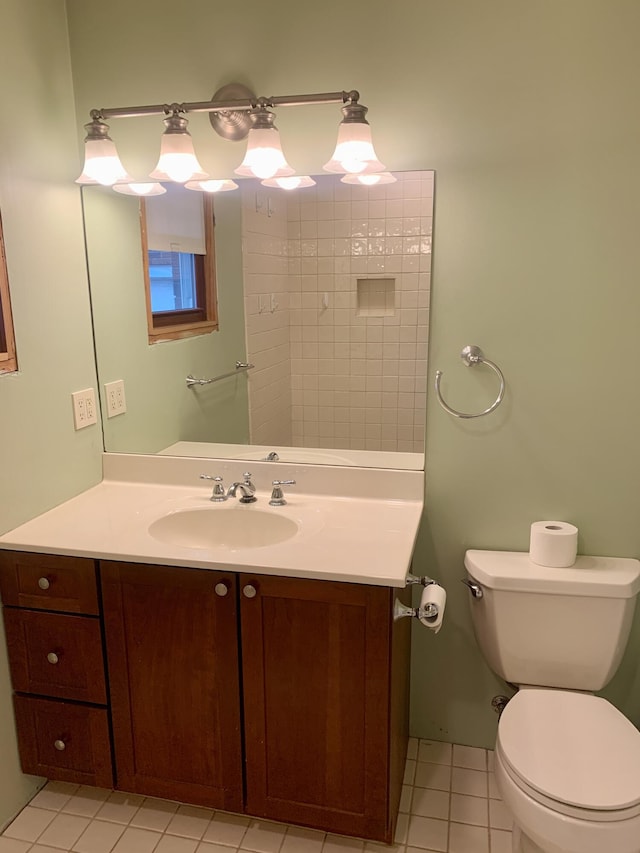 bathroom featuring tile patterned floors, vanity, and toilet