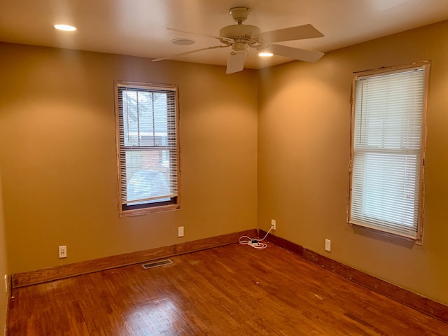 unfurnished room with hardwood / wood-style floors and ceiling fan