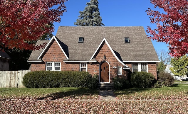 tudor home with a front yard