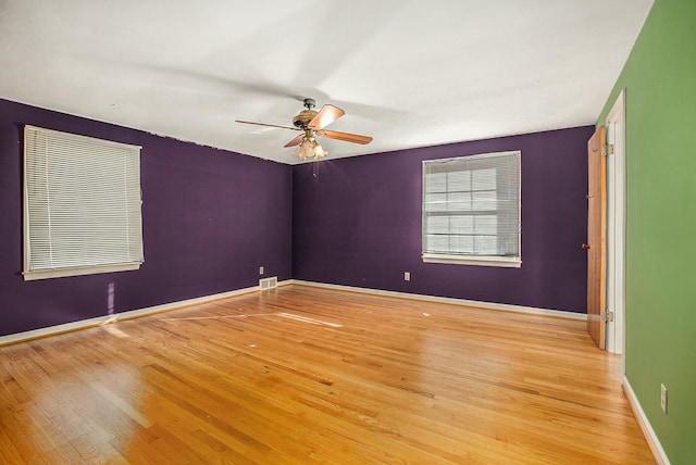 empty room with ceiling fan and light wood-type flooring