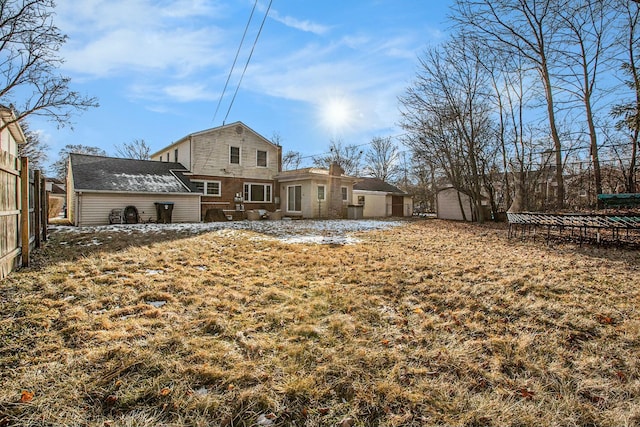 back of property with a yard and a trampoline