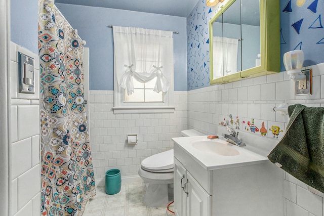 bathroom featuring a shower with curtain, vanity, tile walls, and toilet